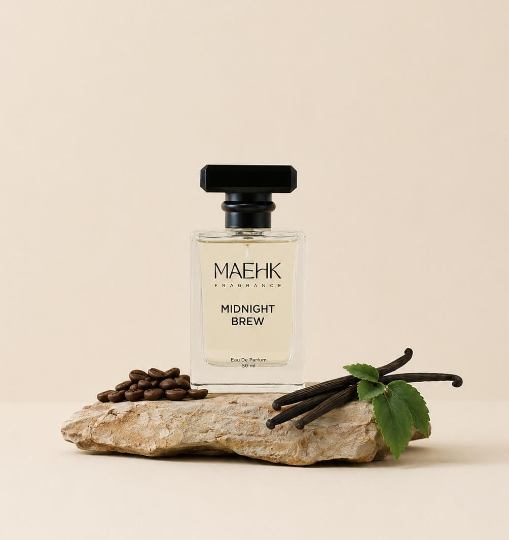 MAEHK Midnight Brew perfume bottle with vanilla beans and coffee beans on a beige background